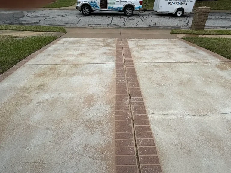 Concrete driveway with brick inlay after pressure washing
