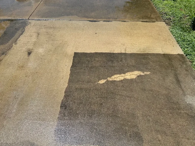Driveway cleaning test area showing dirt removed from concrete