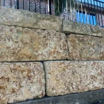 Limestone retaining wall after soft wash cleaning